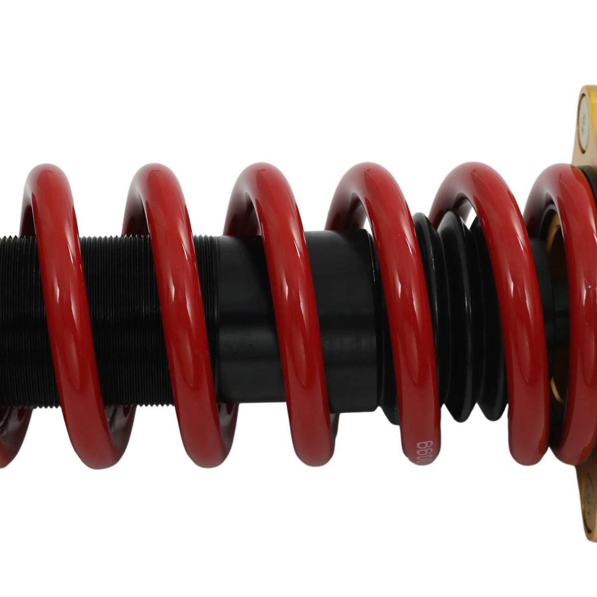 Close-up coil spring section on black shock body with red spring coils.