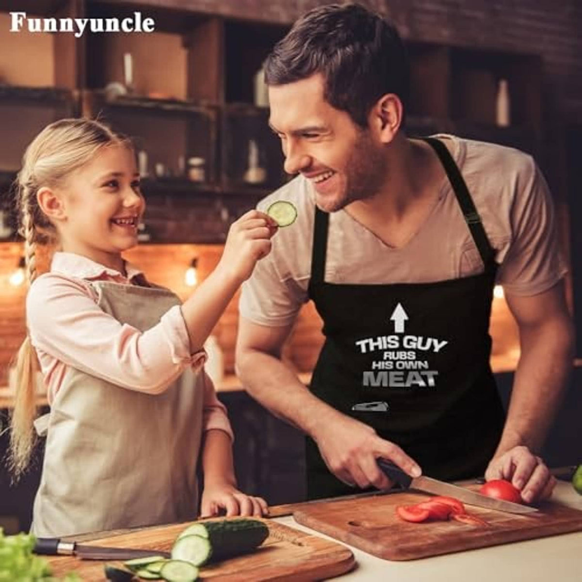 Black BBQ apron with 'THIS GUY RUBS HIS OWN MEAT' front print, worn with adjustable straps