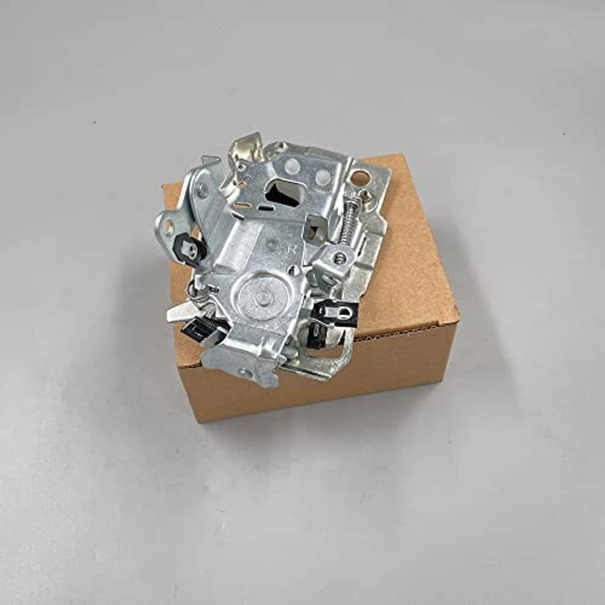 Front door latch lock mechanism, silver metal housing with spring and link on box
