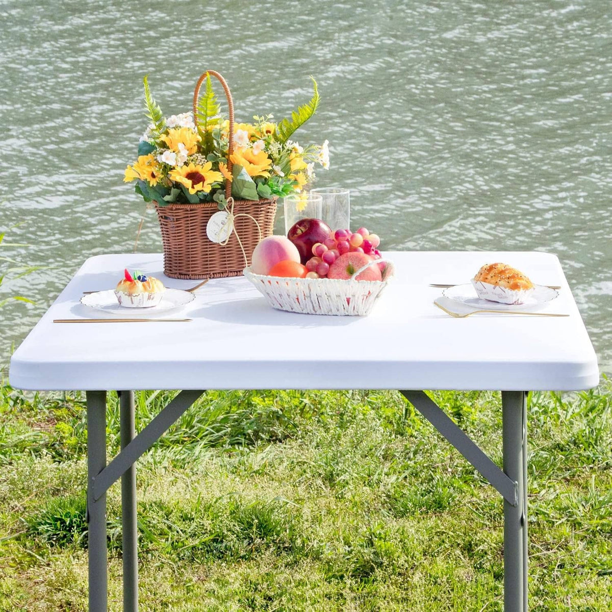Square fitted white table cover on table, neatly draped elastic corners