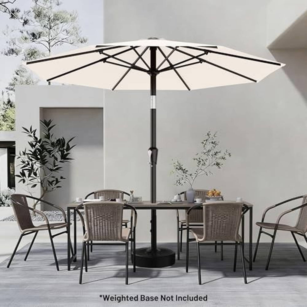 Cream-white patio umbrella with black pole over outdoor dining set