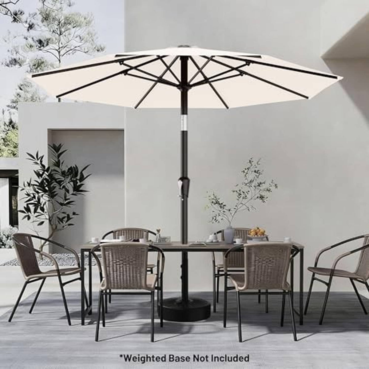Cream-white patio umbrella with black pole over outdoor dining set