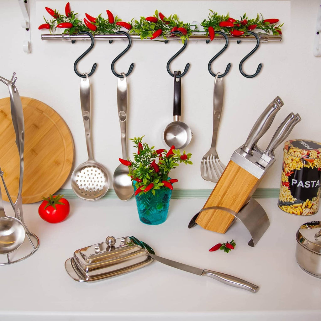 Vinyl-coated black S hooks for hanging utensils on a wall rail