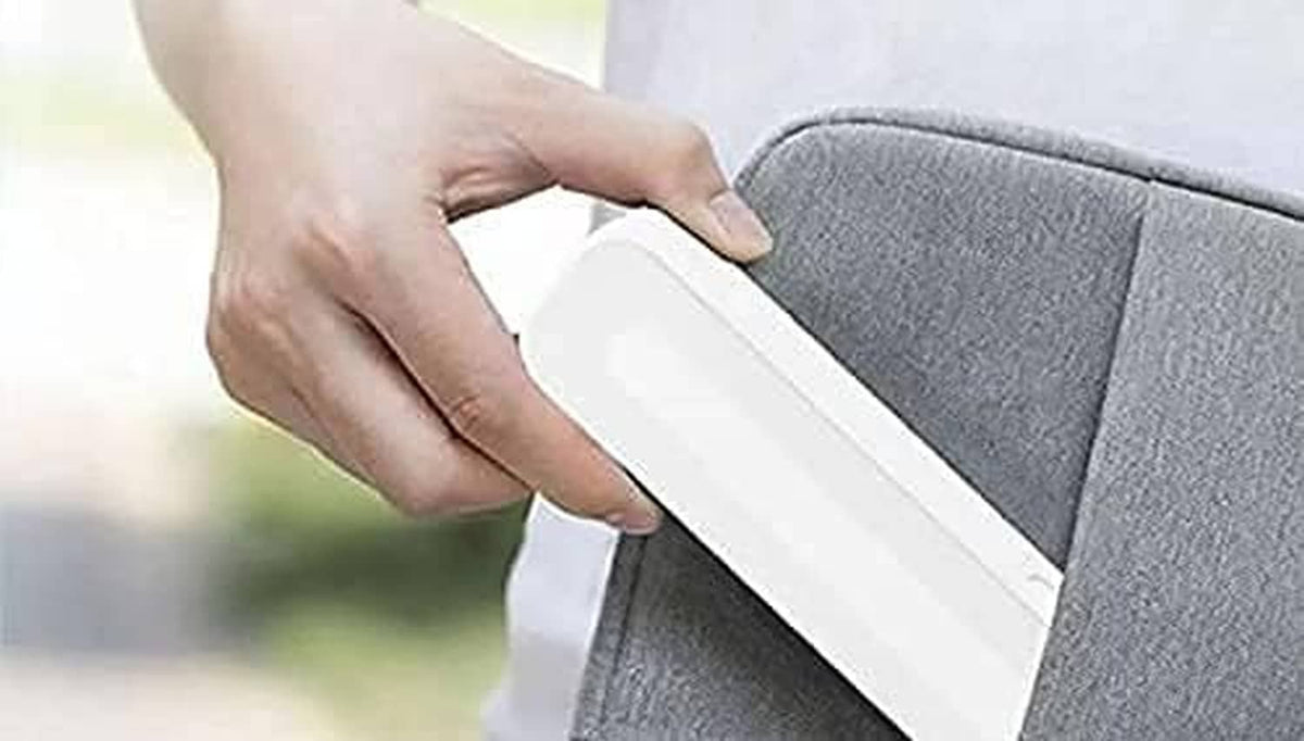 Hand sliding a white and teal stylus case into a protective cover