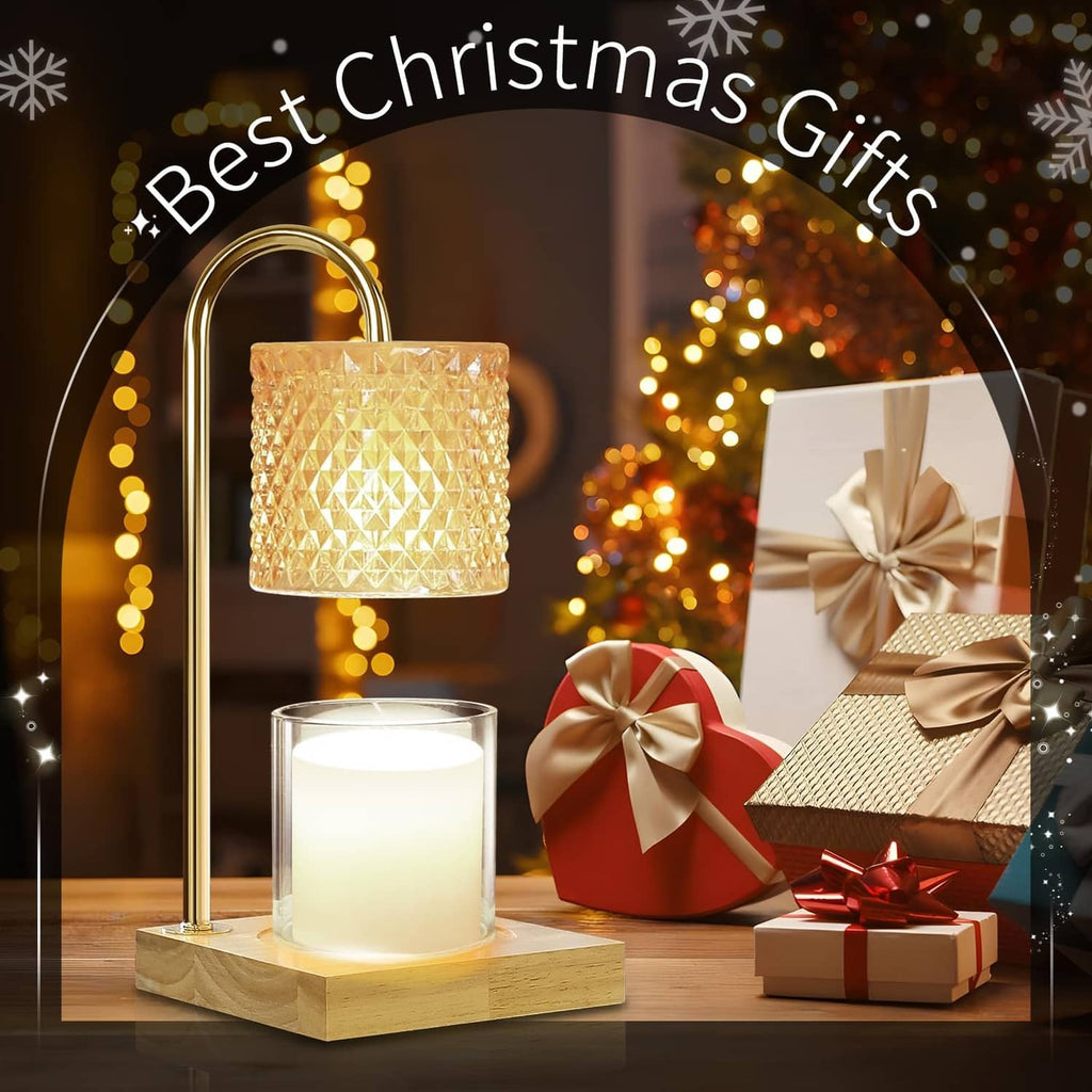 Gold candle warmer lamp with amber textured glass shade and lit candle on wooden base