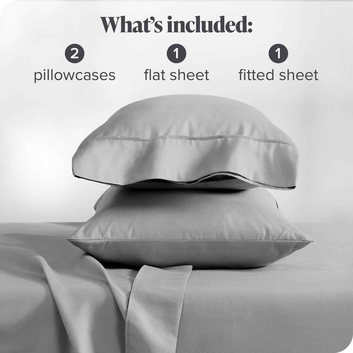 Light grey pillowcases and sheet set shown stacked with flat and fitted sheets