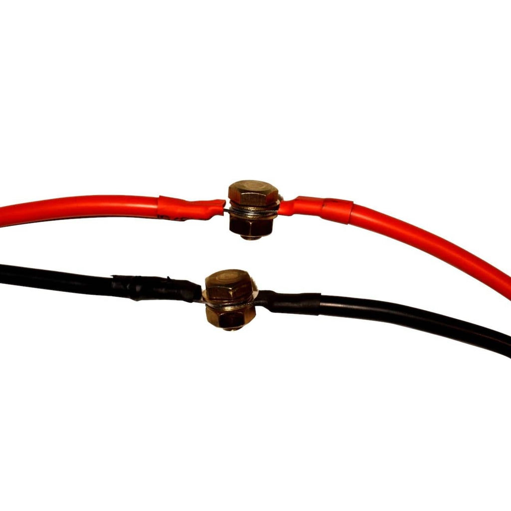 Close-up of red and black battery cable leads with two gold connection ends.