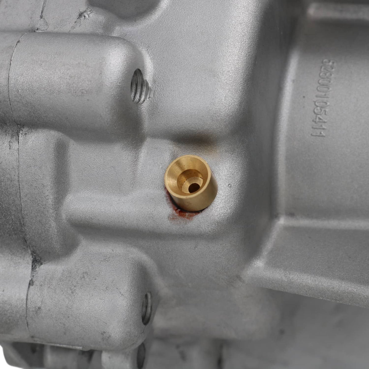 Metal transfer case housing with brass bushing insert and mounting bolt holes