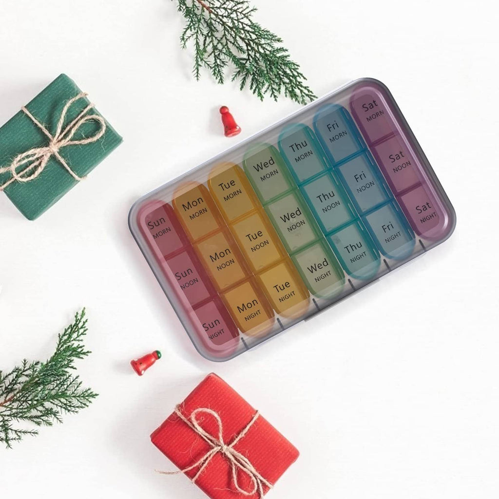 Weekly pill organizer with rainbow day labels and clear lid, closed case