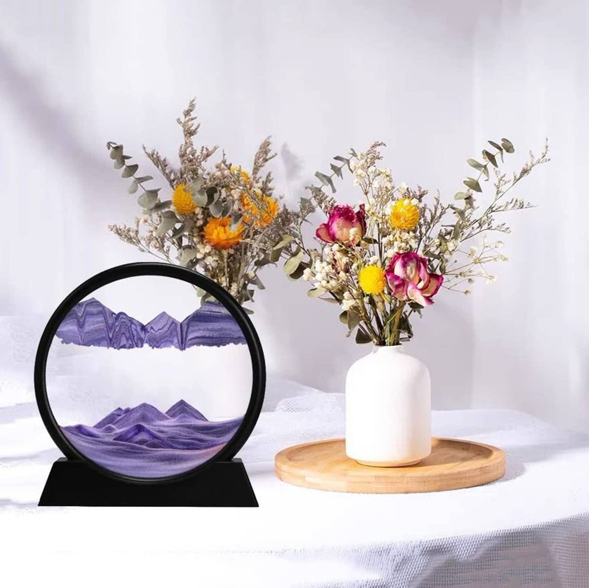 Dynamic sand art sphere with black frame and purple mountain landscape on stand