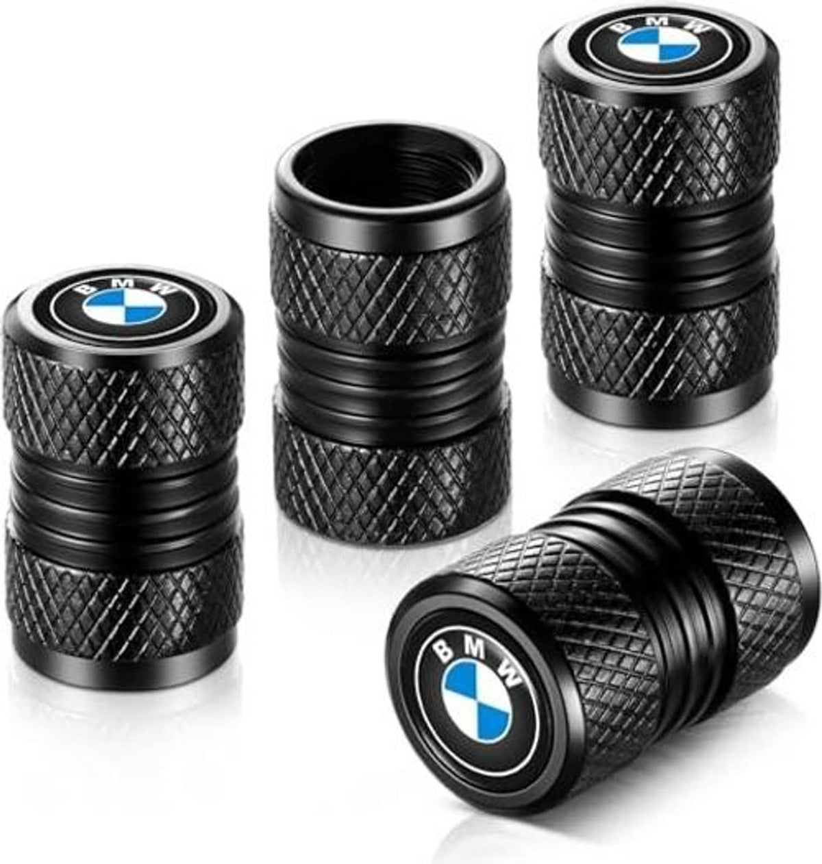 Three black textured valve stem caps with BMW round logo, angled view