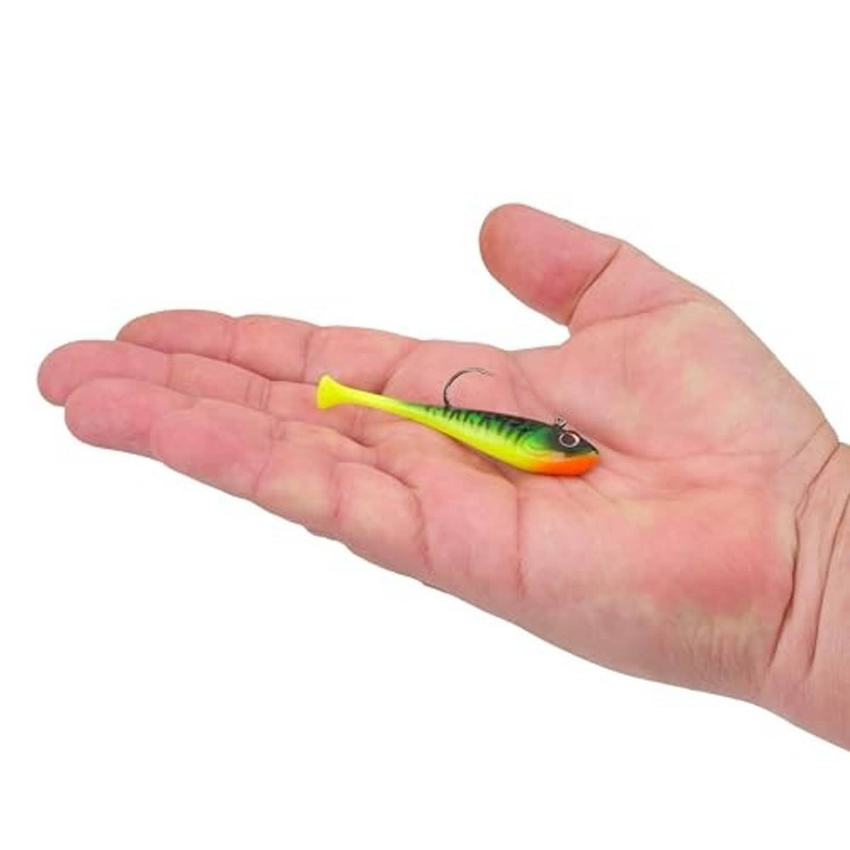 Soft plastic fishing bait in firetiger pattern held in hand with attached hook