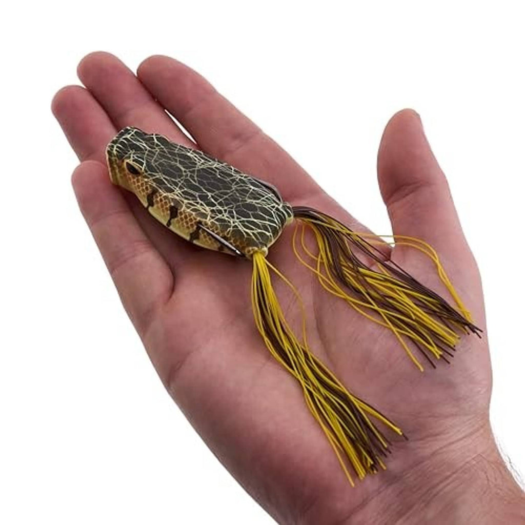 Berkley Swamp Lord popping frog lure in hand, dark net-pattern body and yellow skirt