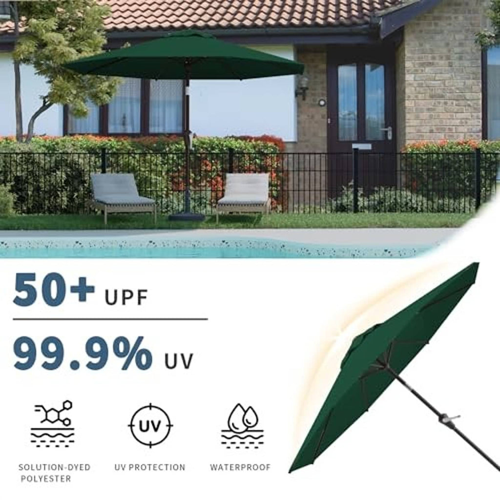 Dark green patio umbrella angled over an outdoor patio with table and chairs