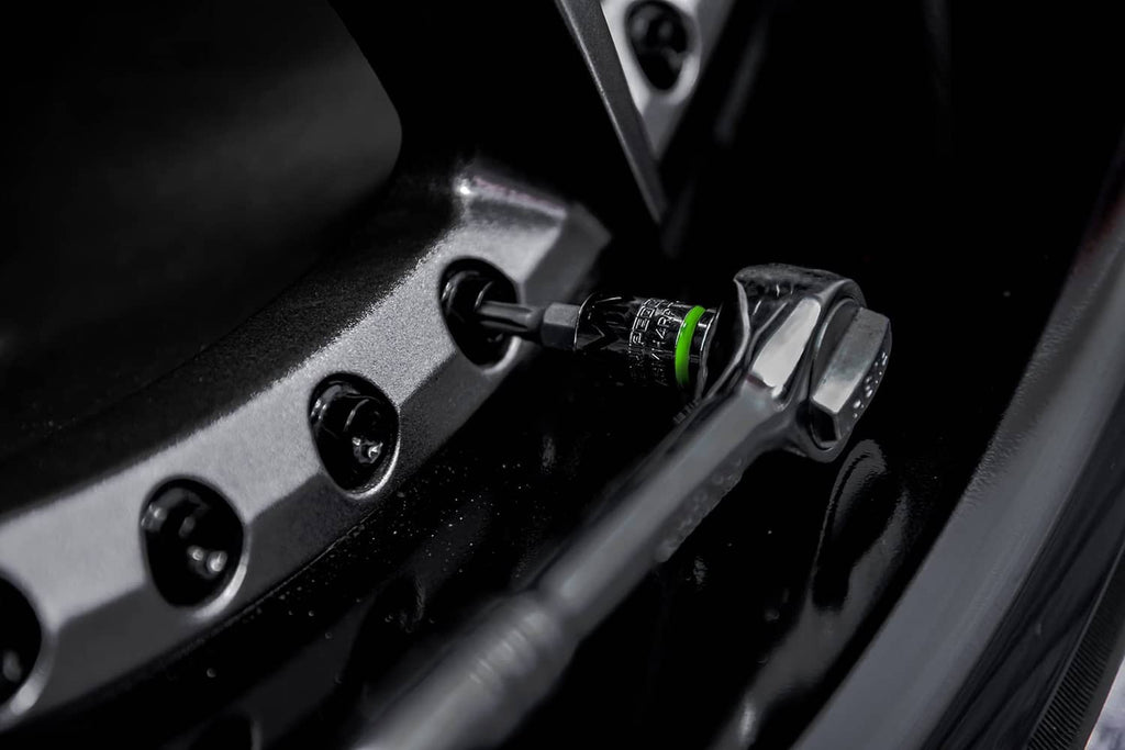 Hex bit socket inserted in a lug area, green ring and socket markings visible
