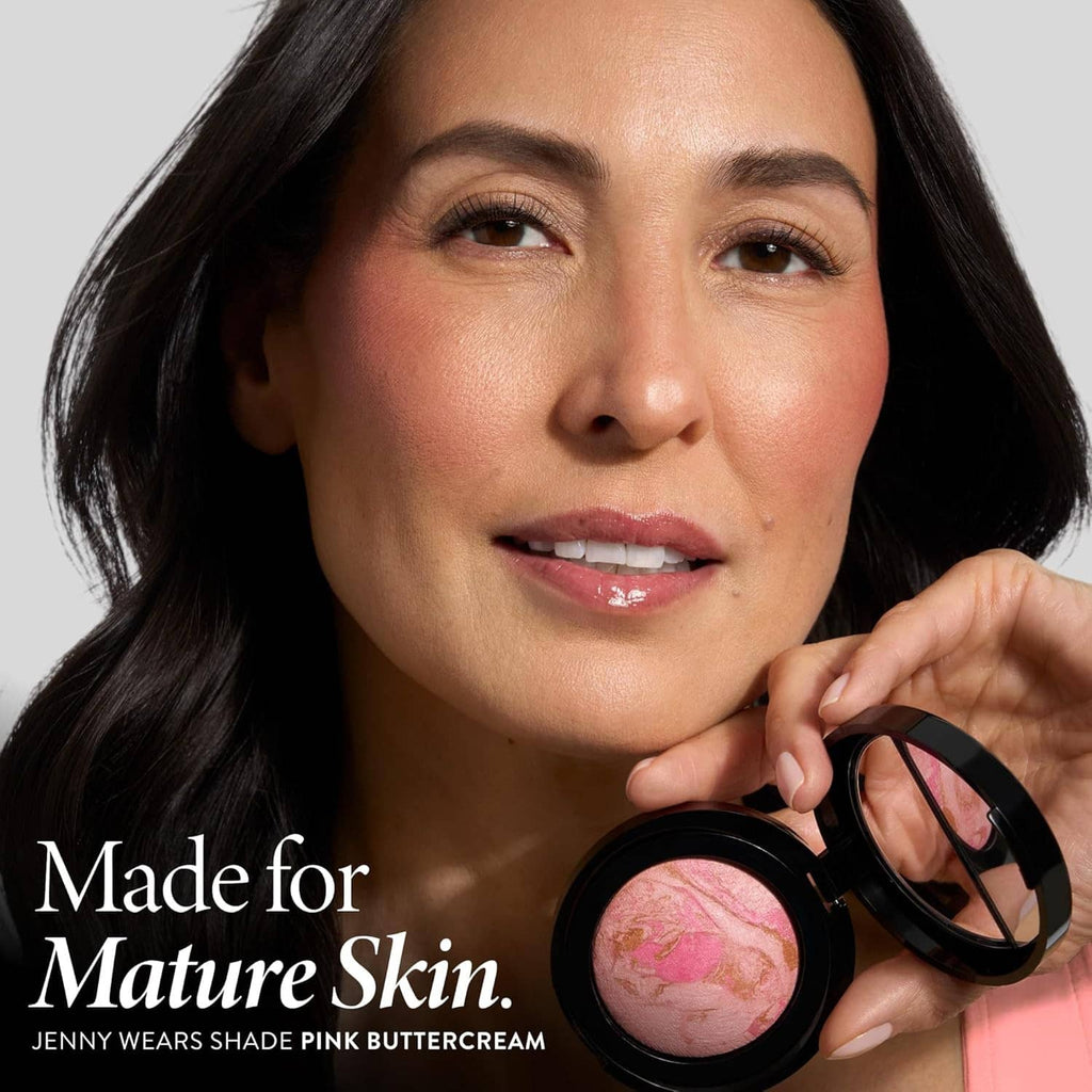 Woman holding a powder blush compact with pink buttercream shade