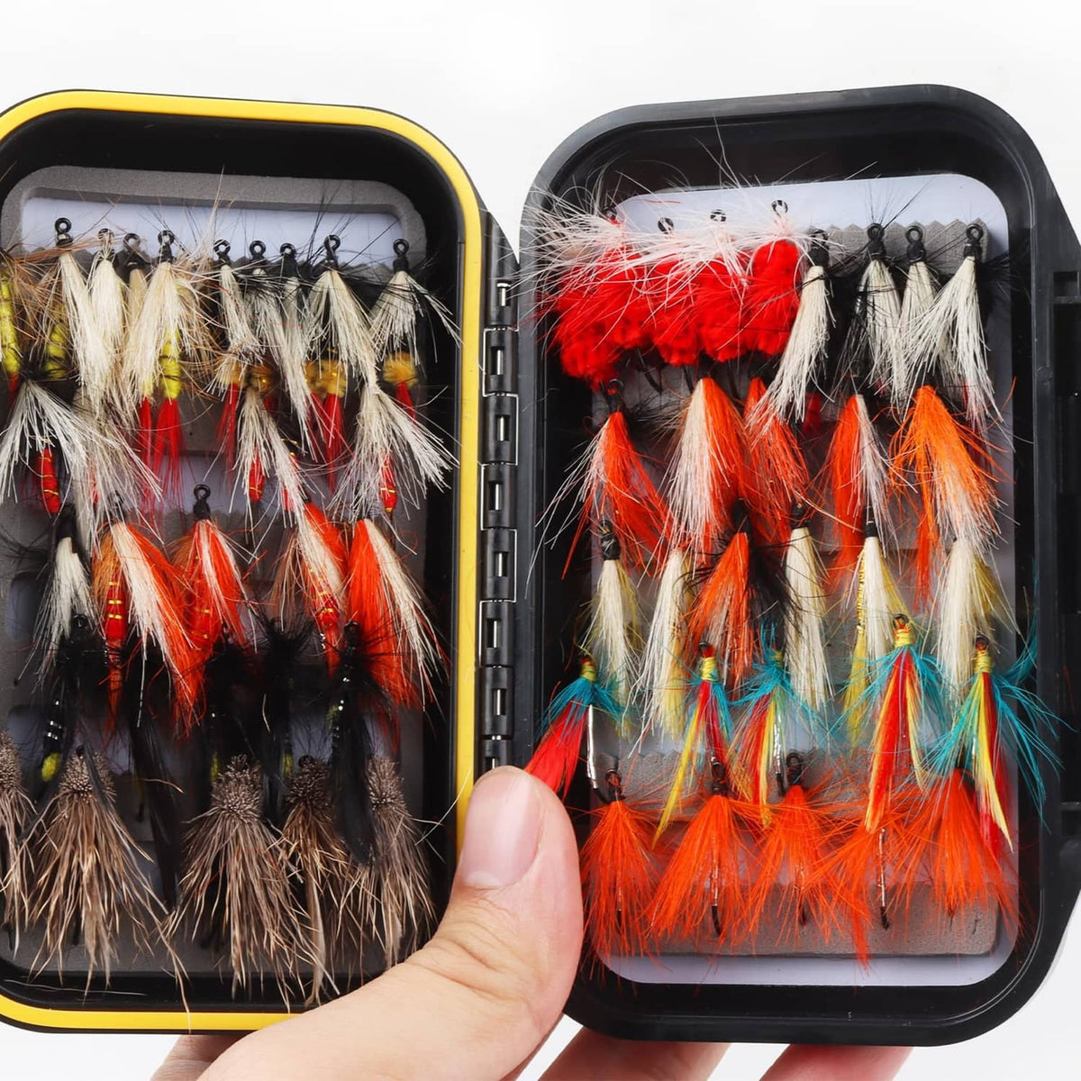 Waterproof fly box holding orange, red, and white feather streamer flies on hooks