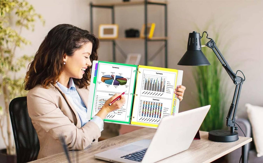 Person organizing with 8-tab binder dividers in a 3-ring binder on a desk