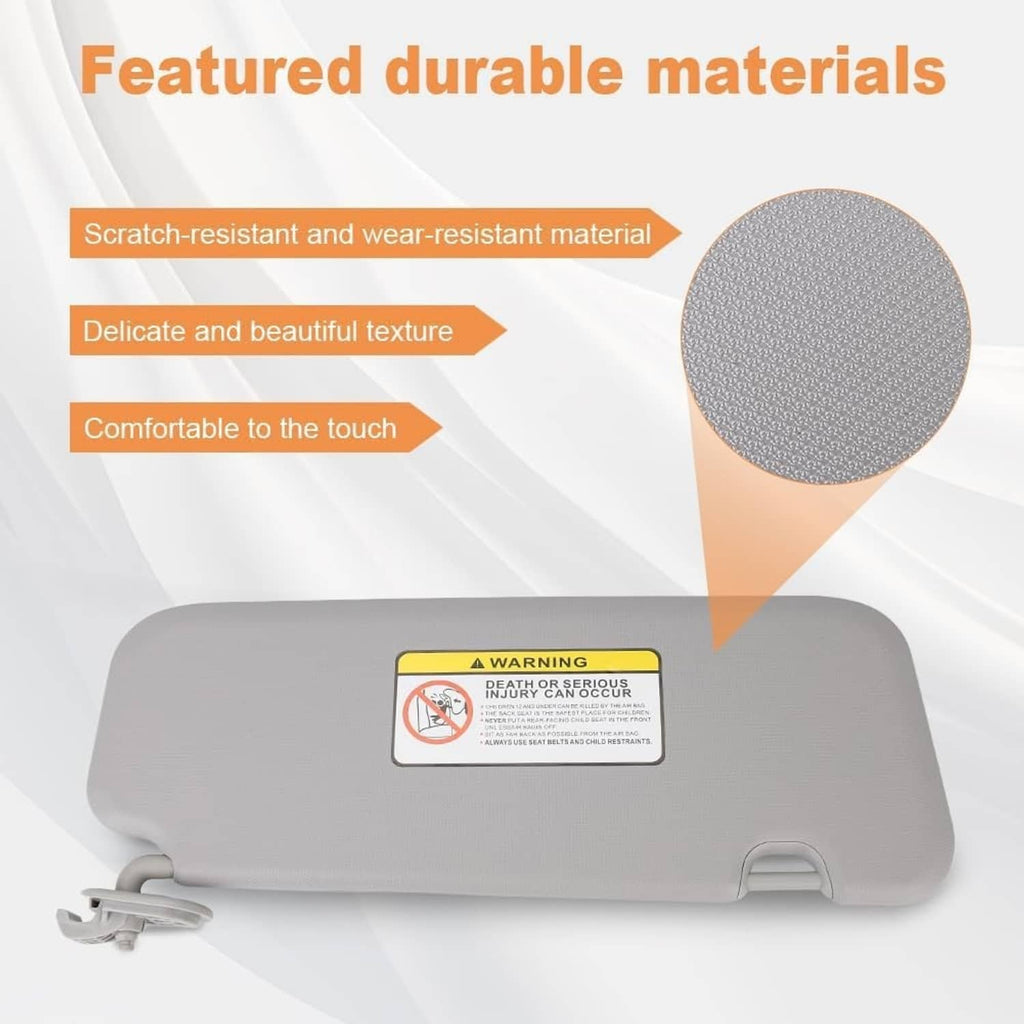 Gray sun visor with warning label and textured surface close-up
