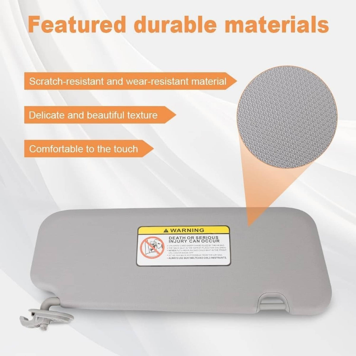 Gray sun visor with warning label and textured surface close-up