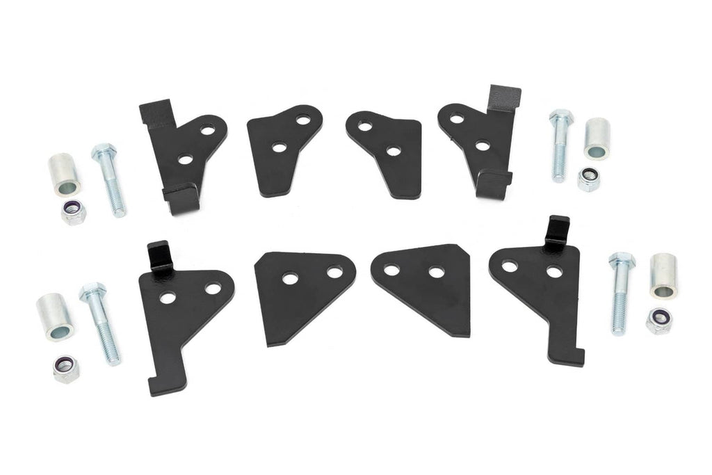 Black suspension leveling bracket set with mounting holes, bolts, and spacers