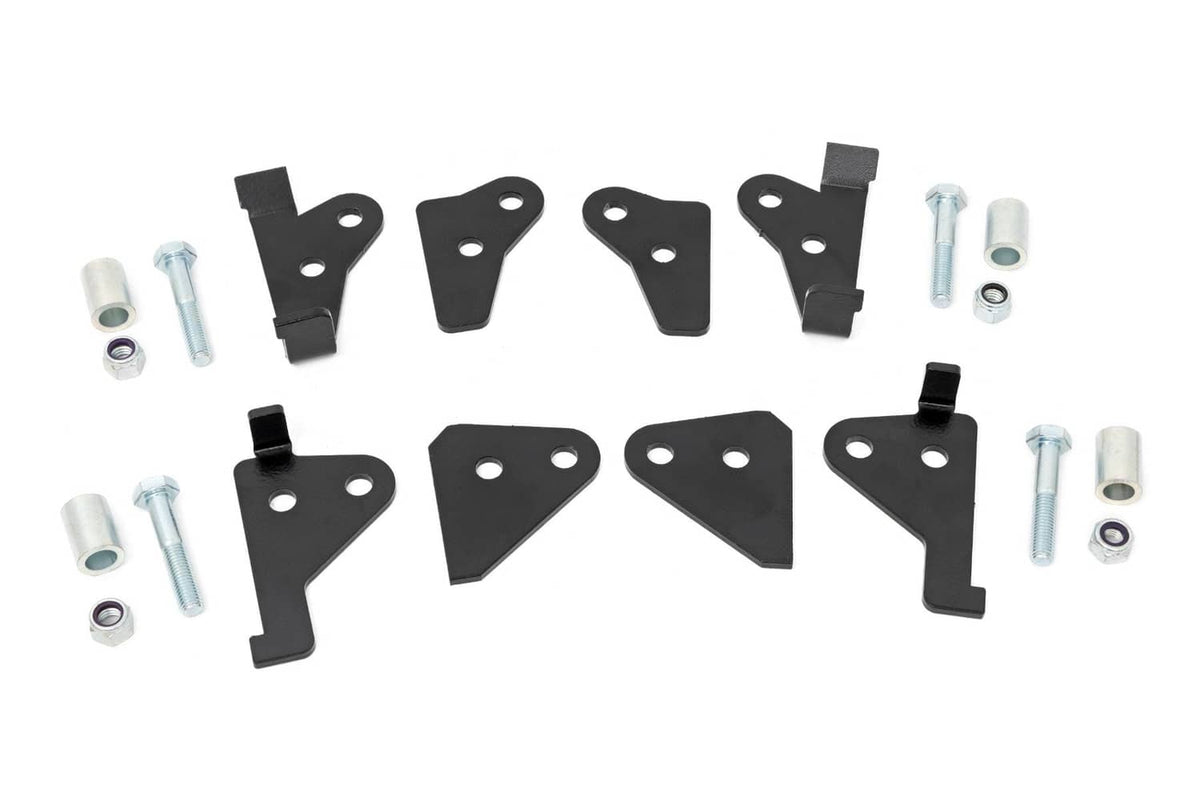 Black suspension leveling bracket set with mounting holes, bolts, and spacers