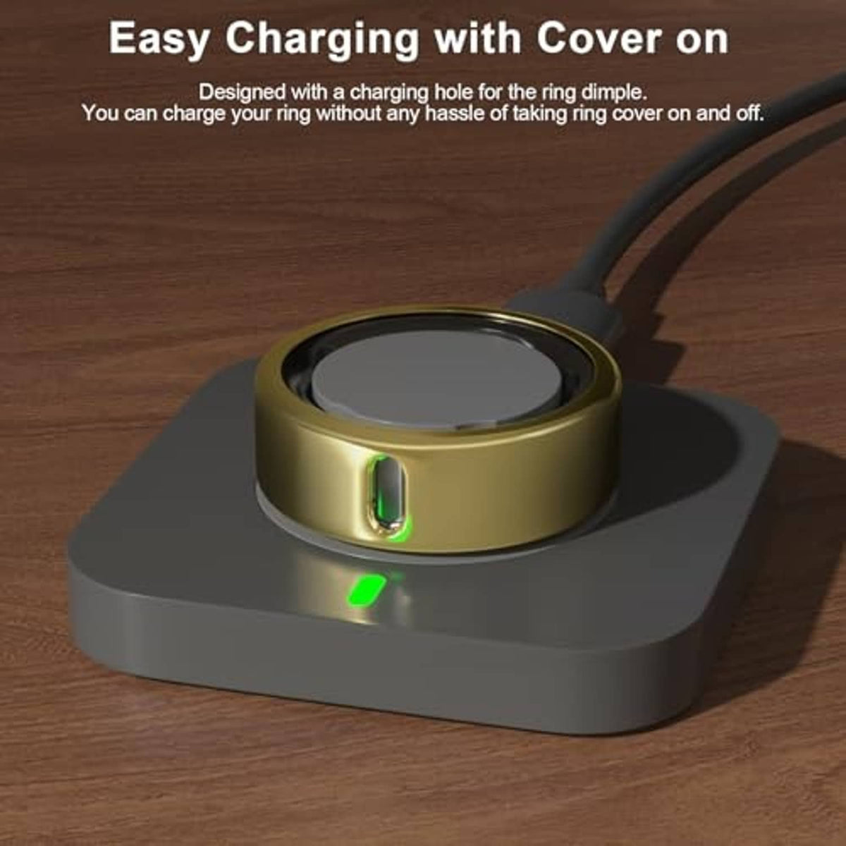 Gold Oura ring cover placed on charging base with green indicator light