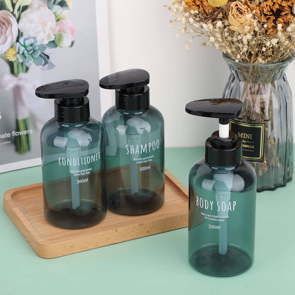 Bath dispenser set with teal bottles and black pumps, including a small mini body soap bottle