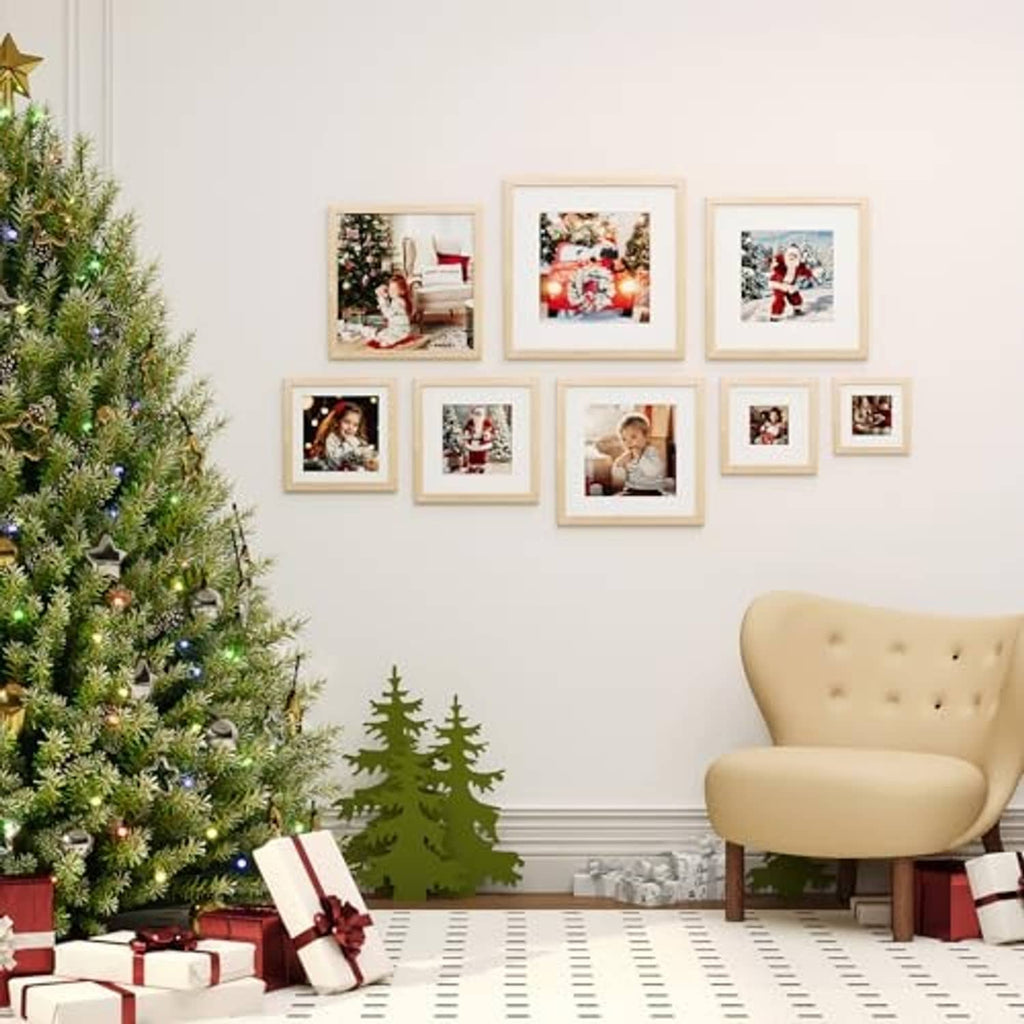 Natural wood square picture frames arranged on a wall above a bench near a decorated tree