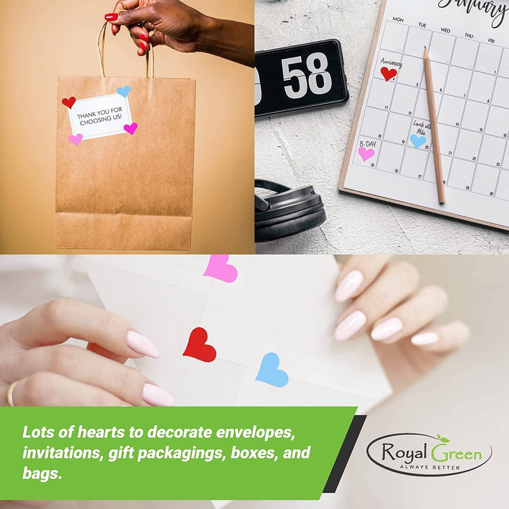 Assorted heart stickers being placed on brown envelope and card surfaces
