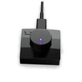 Black ring charger dock with purple-lit indicator on circular top and attached cable