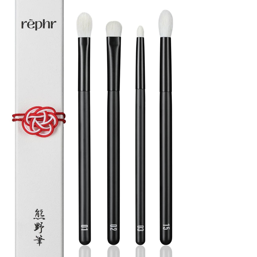 4 eye makeup brushes with black handles and cream bristles with protective sleeve