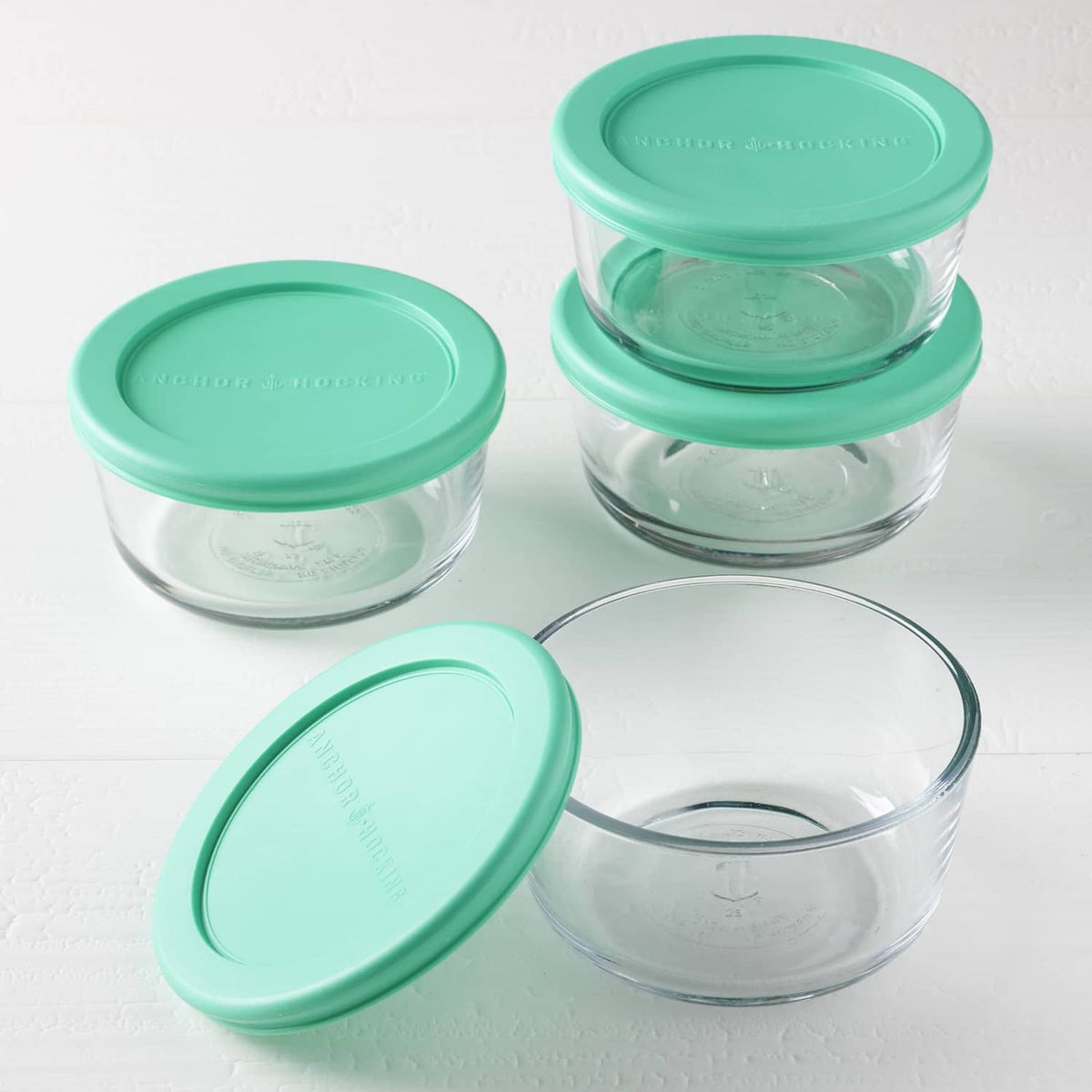 Round glass storage containers with teal lids, mixed set arrangement