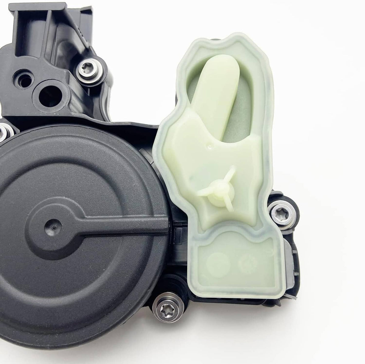 PCV valve oil separator close-up of black circular cover and light green sensor housing