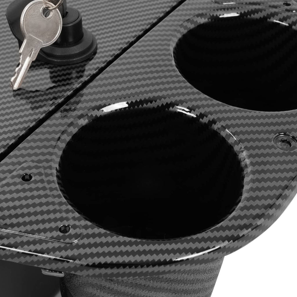 Carbon fiber-style dash compartment close-up of key cylinder and large cup holder
