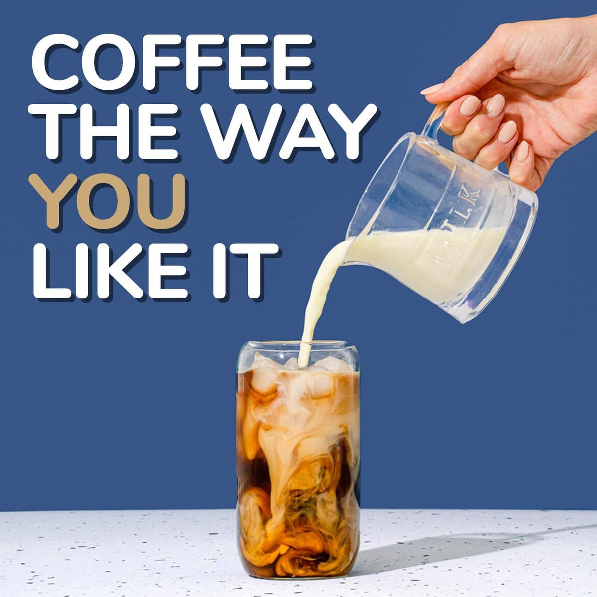 Coffee being poured into an iced glass with single-serve coffee cups