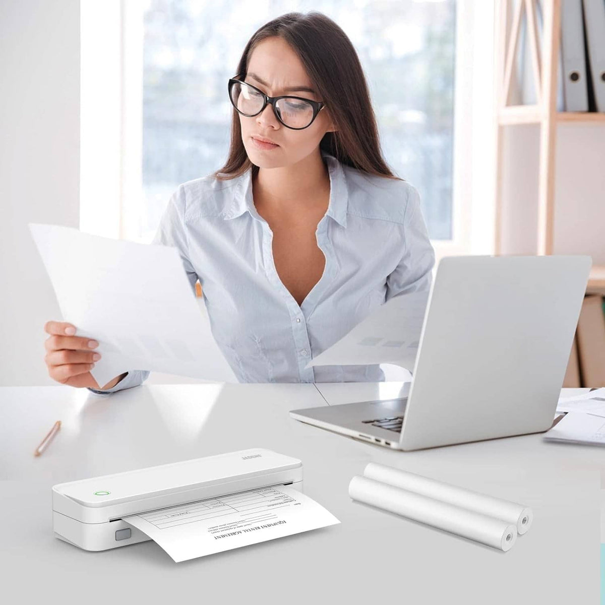 Desktop thermal printer with roll paper and stacked printed receipt sheets