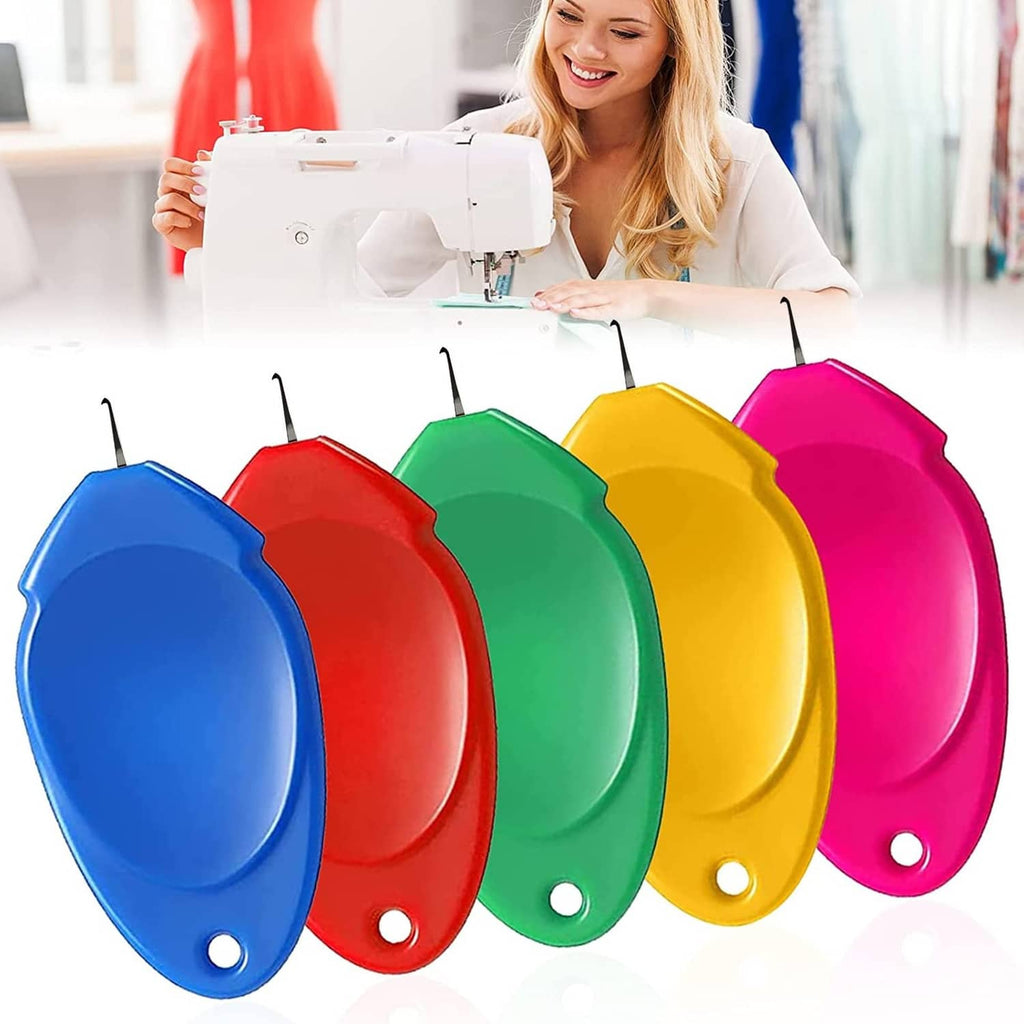 Multicolored needle threaders display near sewing machine, five oval colors on hooks