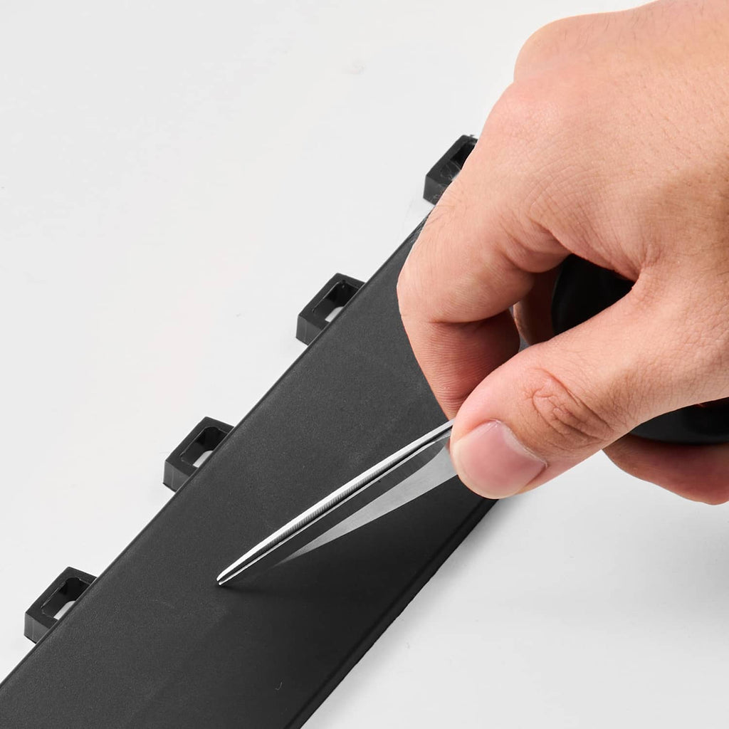 Hand snapping black interlocking garage floor edge pieces together with tabs