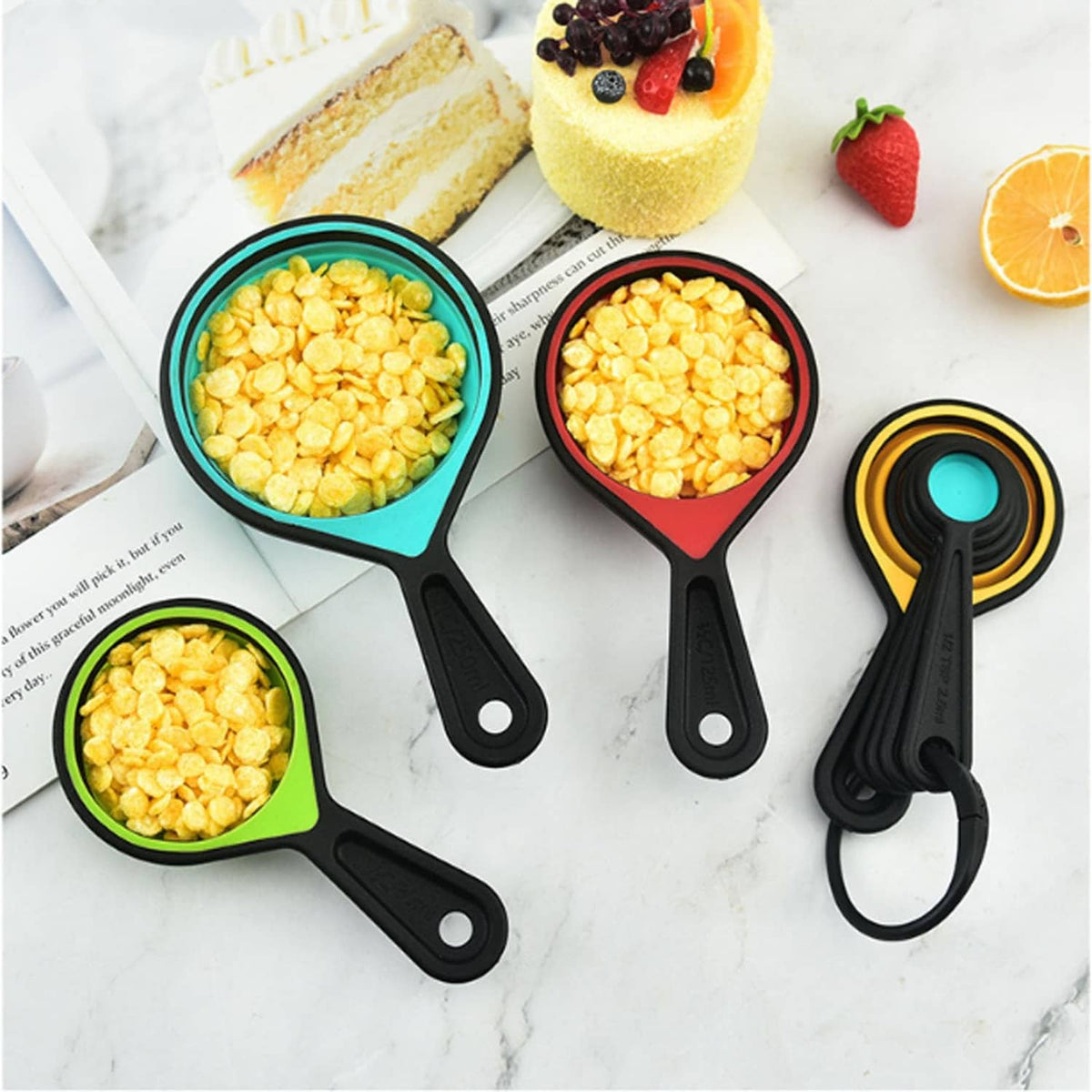 Multicolor collapsible measuring cups filled with yellow kernels, with black handles