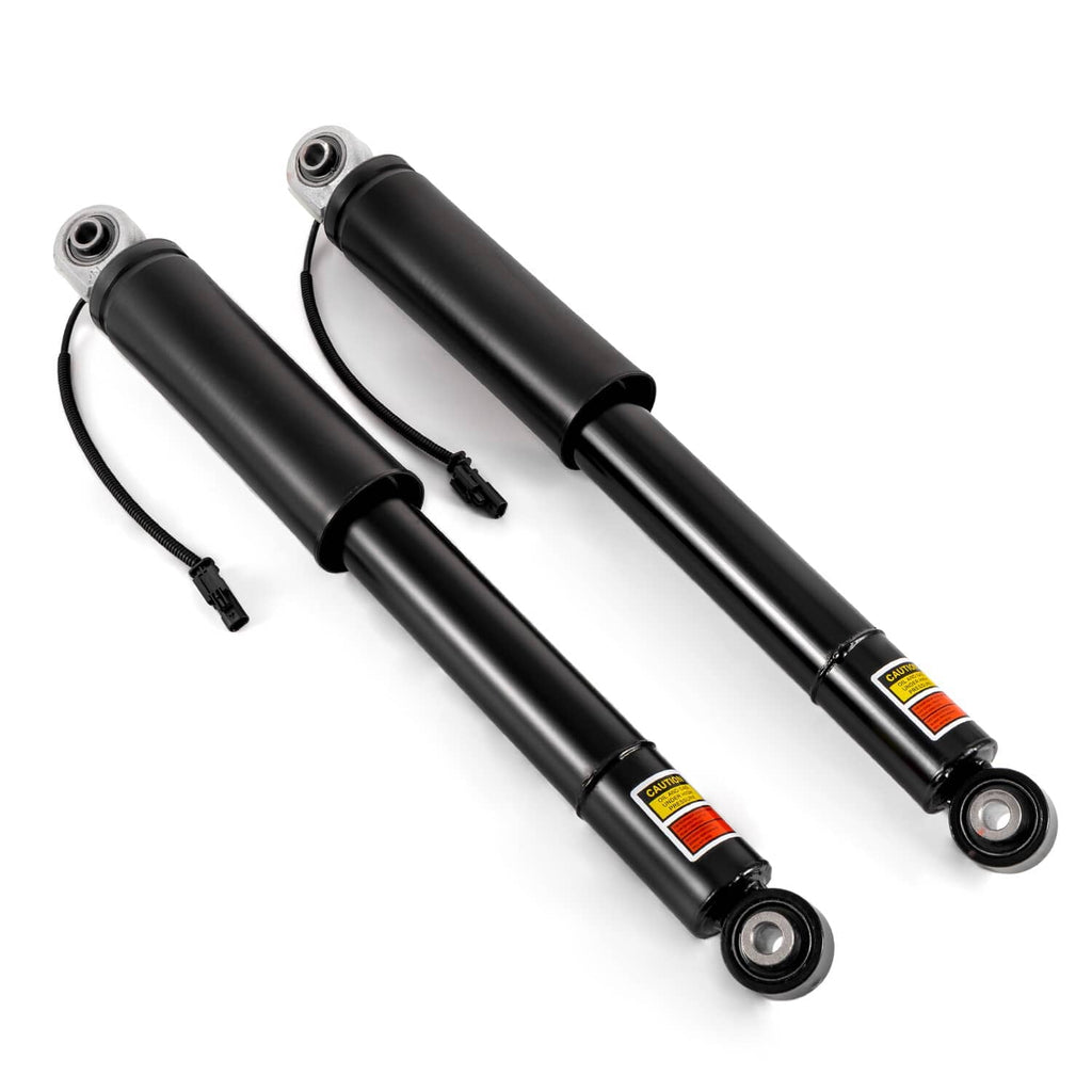 Two black rear shock absorber struts with bushing mounts and attached electrical connectors