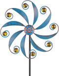 Blue metal wind spinner with curved blades, jeweled center, and gold accent rings on black pole.