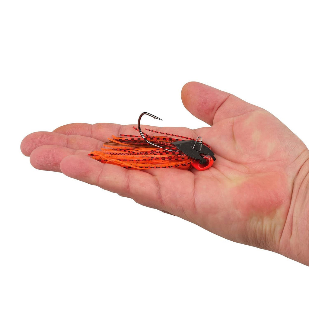 Orange and red bladed fishing jig with black head, skirt, and curved hook in hand