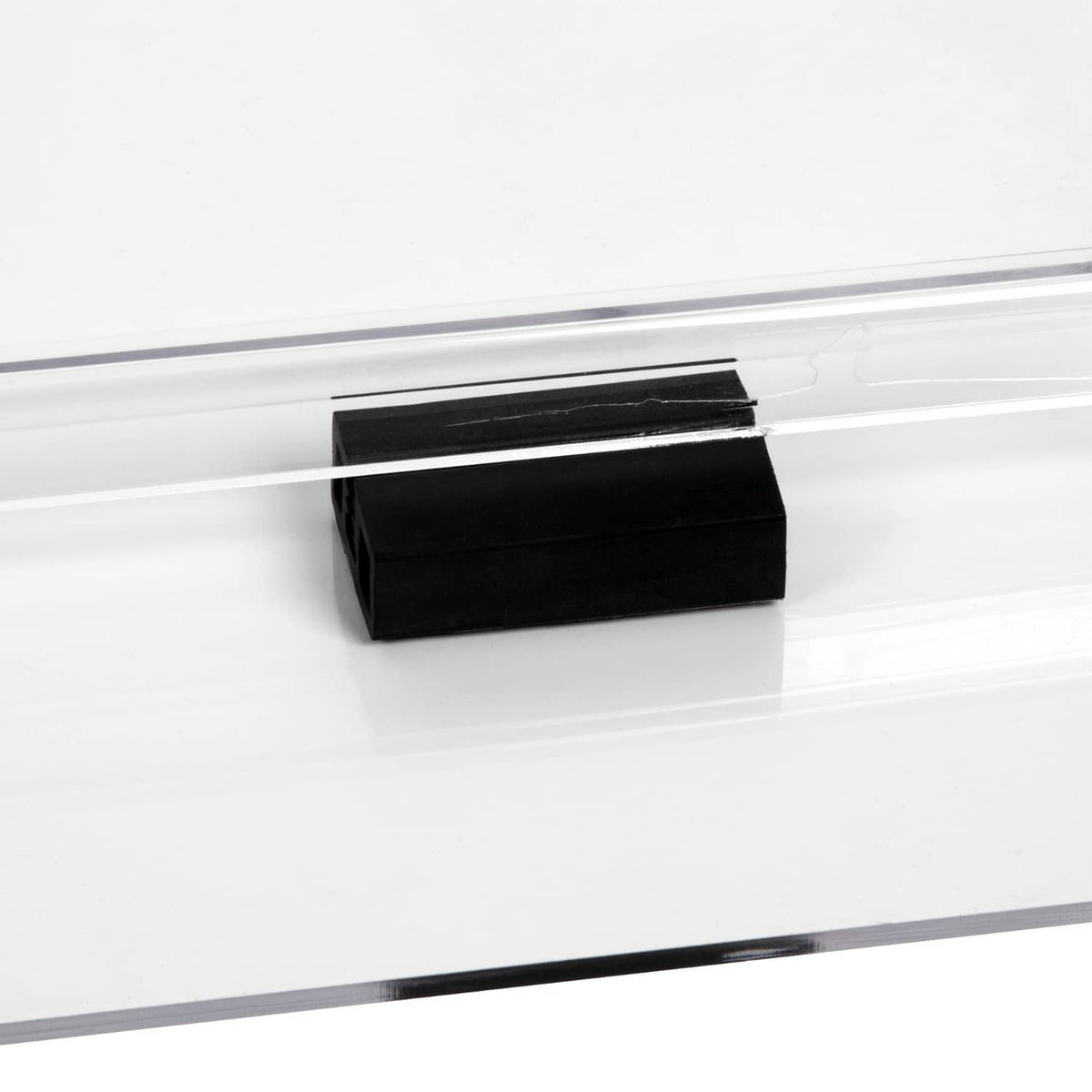 Clear polycarbonate golf cart windshield with black folding latch bracket on edge