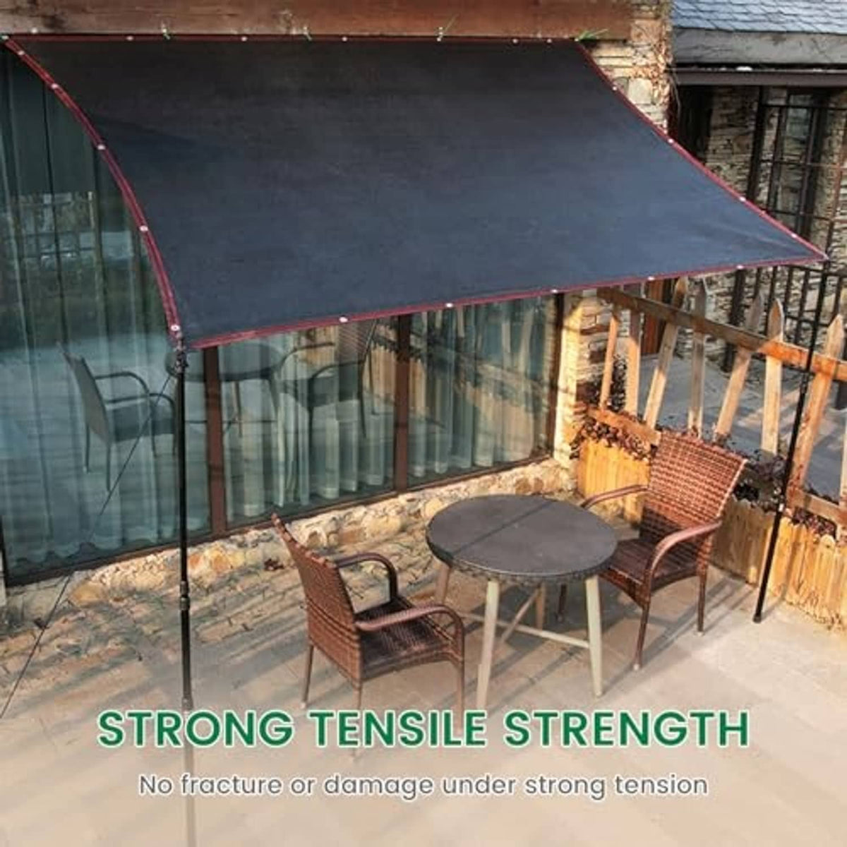 Outdoor shade cloth canopy stretched over patio area with dark woven fabric