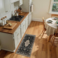 Black and beige rectangular area rug runner with ornate floral medallion border