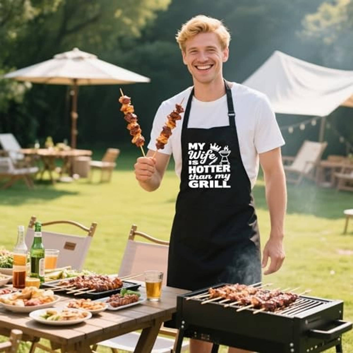 Black BBQ apron on man with 'MY Wife is HOTTER than my GRILL' front print