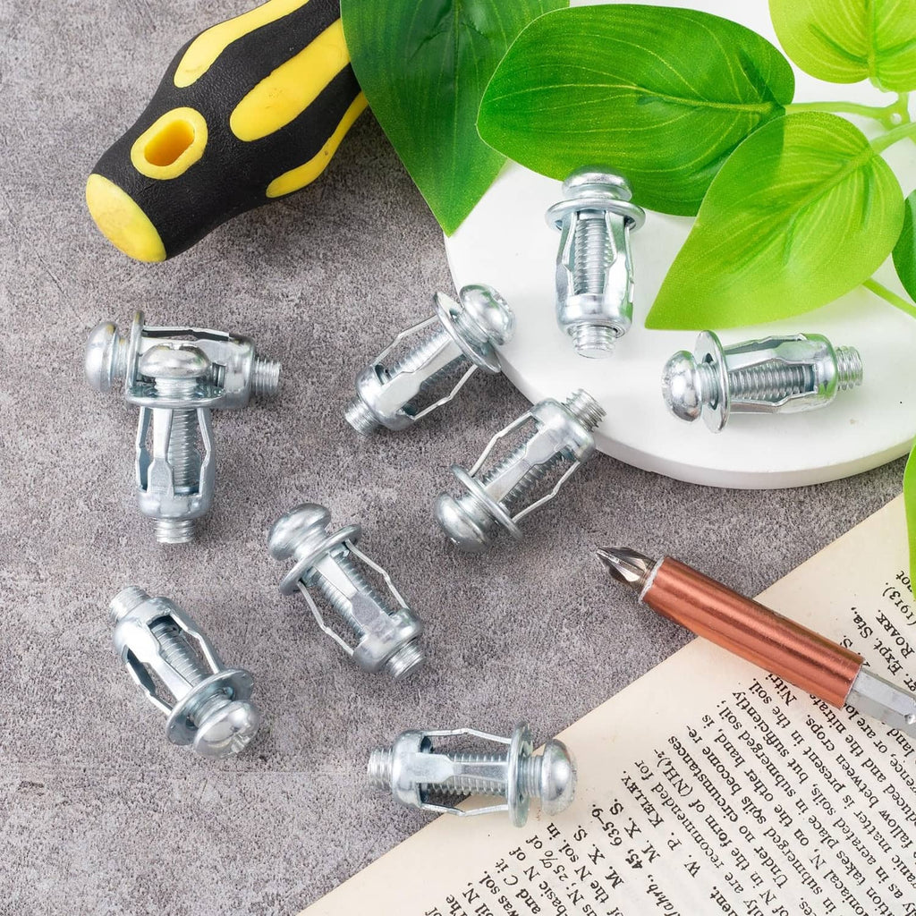 Silver M8 expansion screws with petal nuts, scattered on white plate