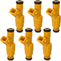 Six yellow fuel injectors with black rubber tips and electrical connectors