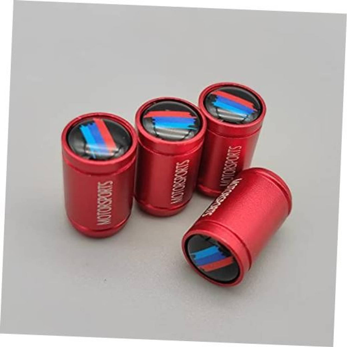 Red wheel valve stem caps with blue stripe inserts, chrome-style caps